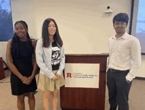three student interns posing at the podium